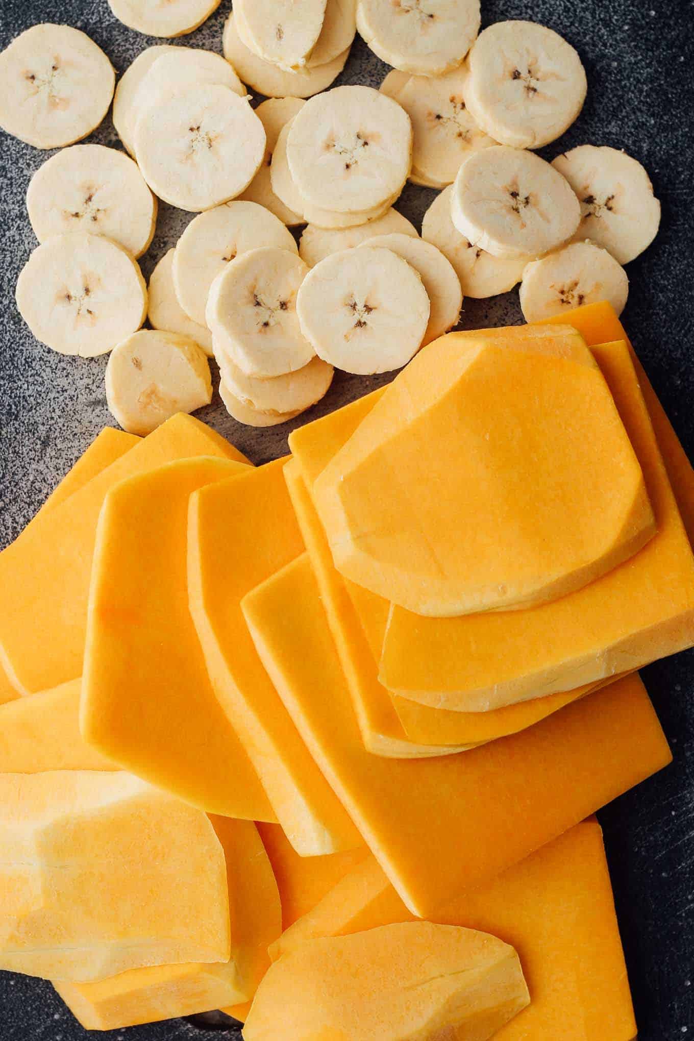 A cutting board full of butternut squash and plantain slices