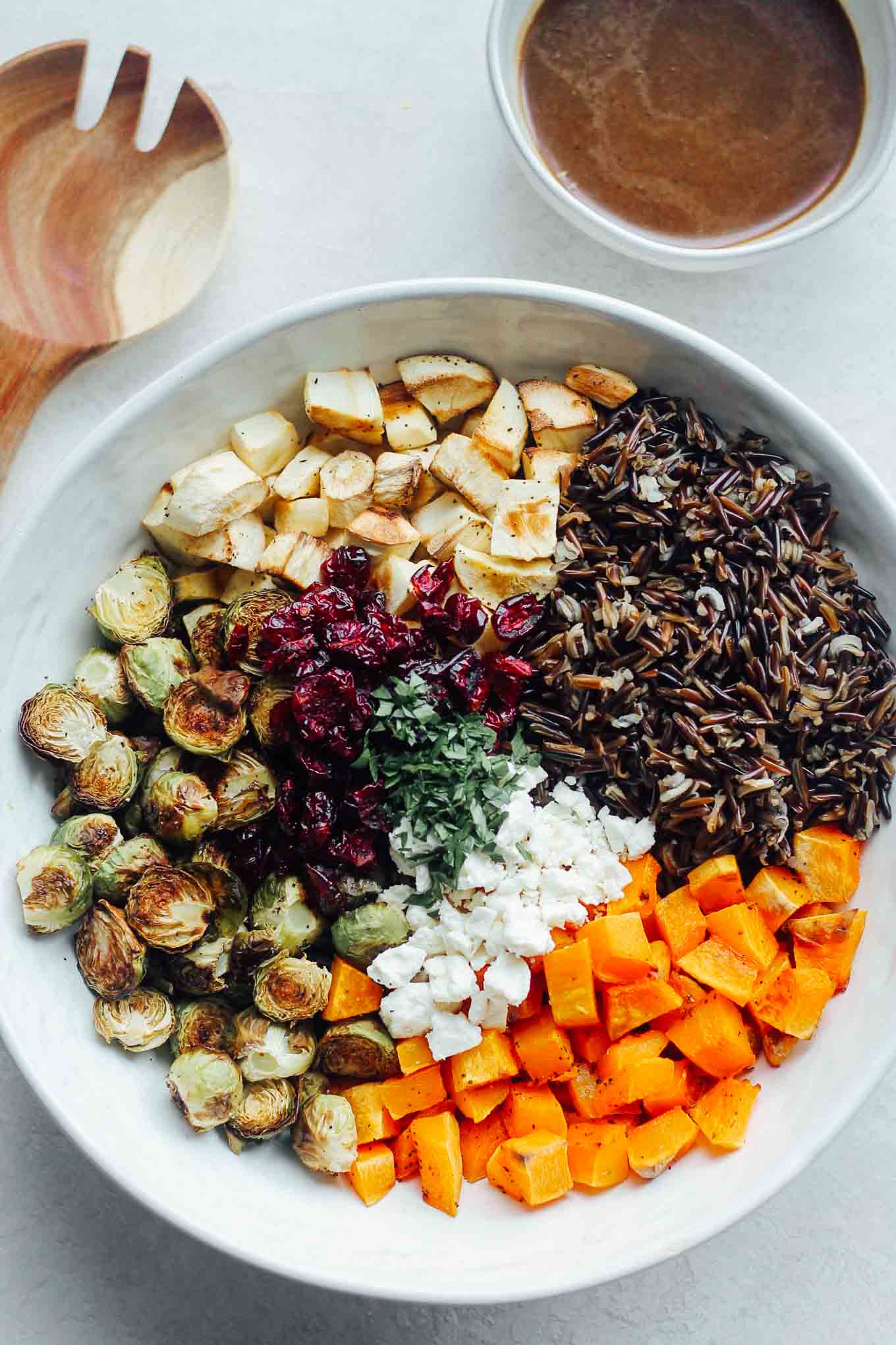An overhead view of each ingredient in the bowl before tossing with dressing