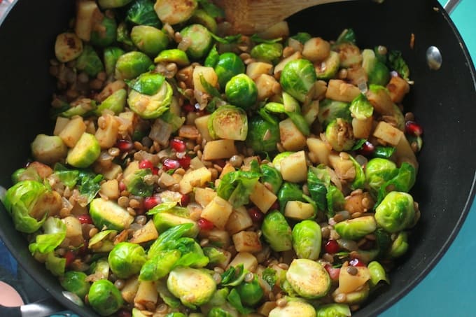 Brussels Sprout, Sweet Potato, and Lentil Saute | Destination Delish - a sweet and savory blend of veggies sautéed with warm spices and topped with juicy pomegranate arils