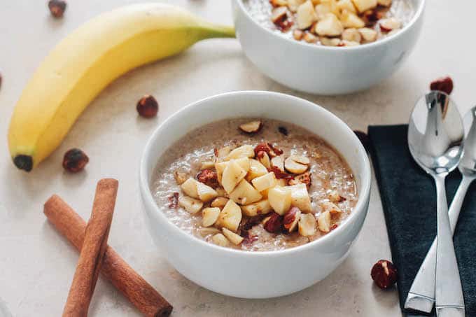 Banana Hazelnut Breakfast Quinoa | Destination Delish - Cozy up to a bowl of this wholesome breakfast quinoa with chopped hazelnuts and bananas and sweetened with maple syrup.