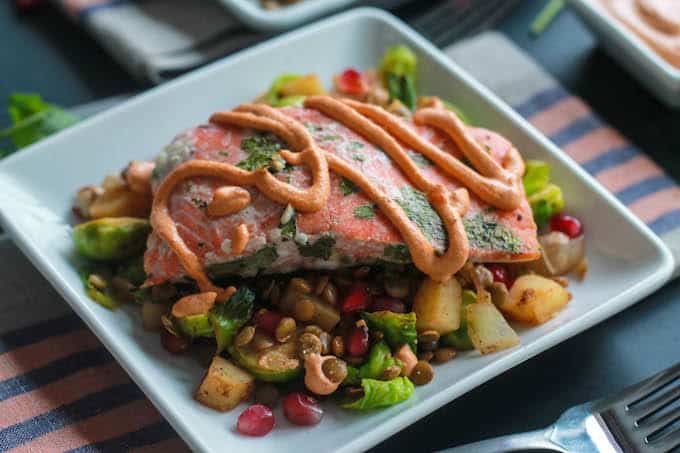 Cilantro Lime Baked Salmon with Chipotle Cashew Cream | Destination Delish - Zesty salmon baked until tender and flaky and topped with a creamy and spicy cashew sauce