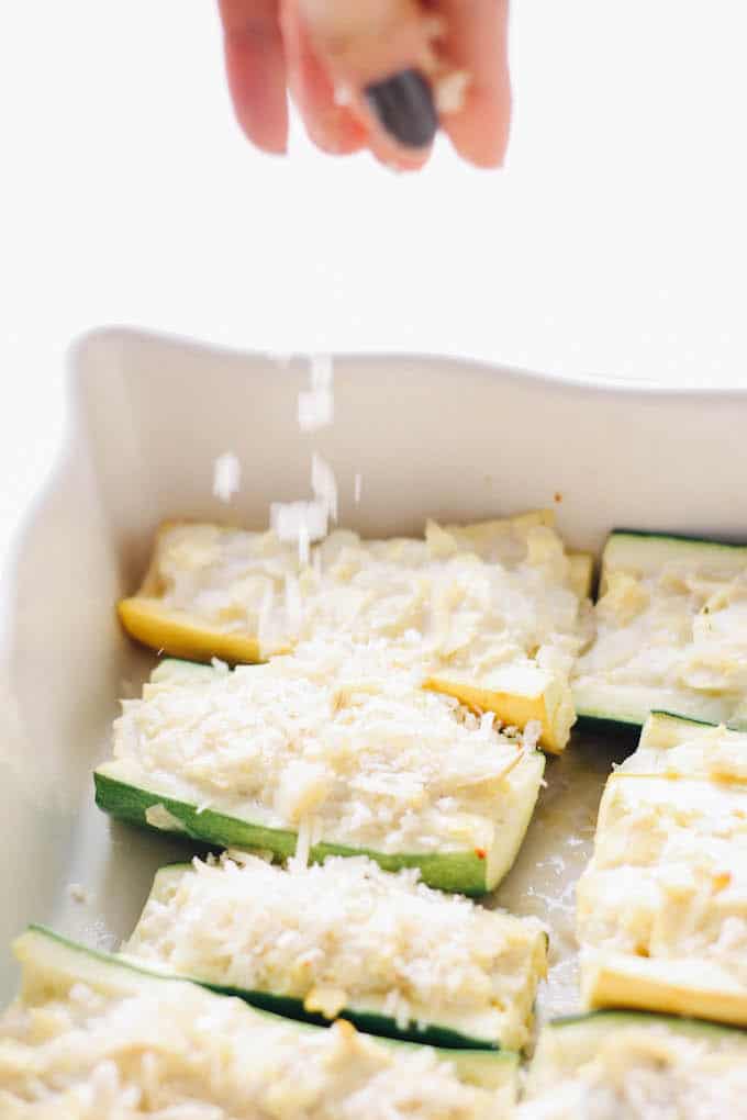 Mini Artichoke Dip Zucchini Boats - Creamy, lightened up artichoke dip packed inside mini zucchini boats!