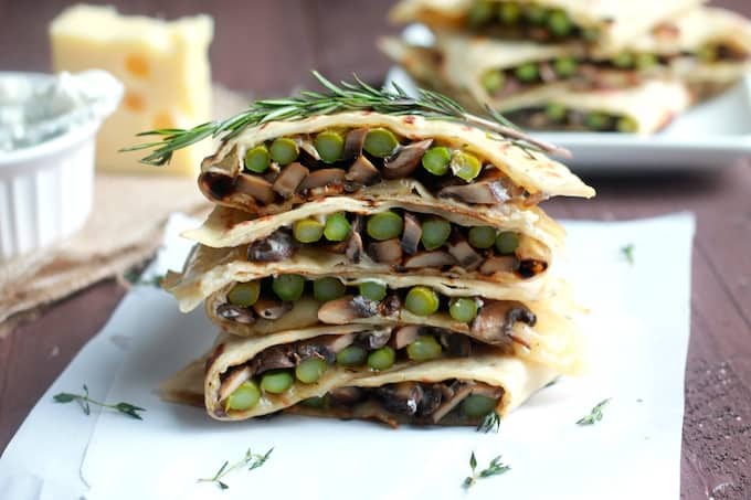Asparagus, Mushroom, and Swiss Flatbread Melts | Destination Delish - Warm sandwiches bursting with sautéed veggies, melted swiss cheese, and dunked in a garlic-herb mayo