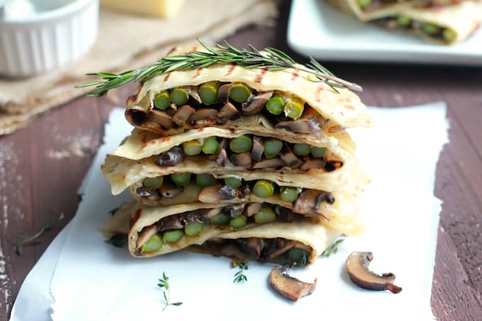 Asparagus, Mushroom, and Swiss Flatbread Melts | Destination Delish - Warm sandwiches bursting with sautéed veggies, melted swiss cheese, and dunked in a garlic-herb mayo