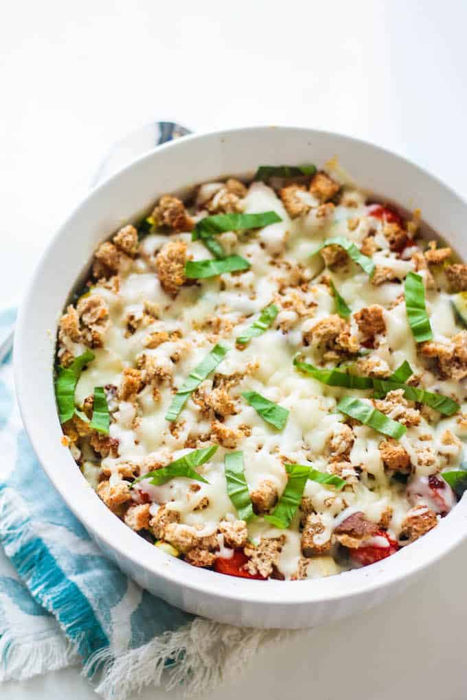 Zucchini, Corn, and Tomato Casserole | Destination Delish - An Italian inspired dish celebrating summer produce topped off with crispy bread cubes and melted mozzarella