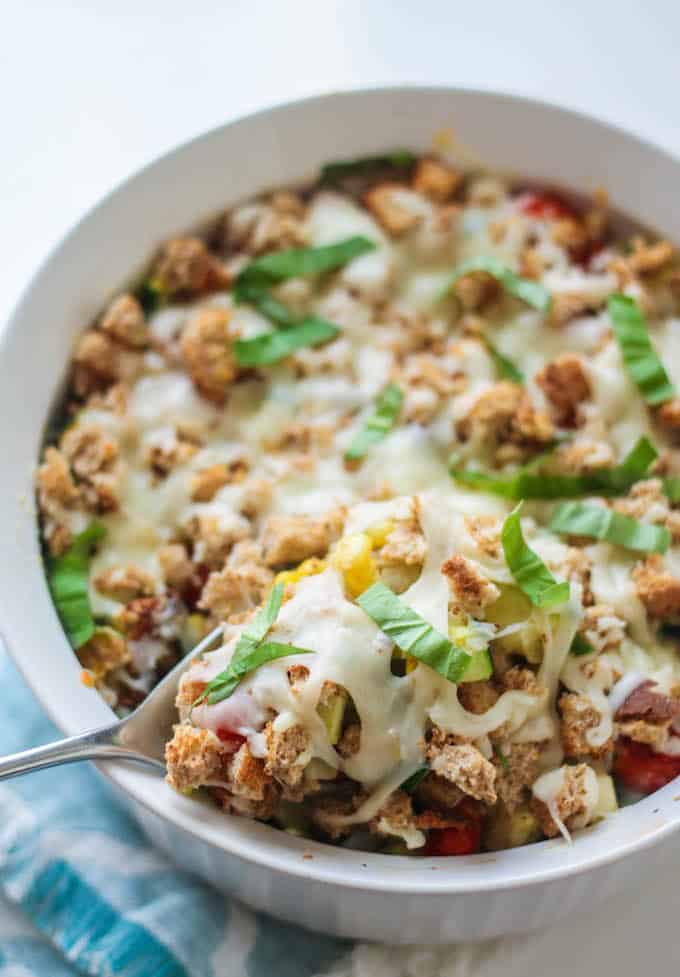 Zucchini, Corn, and Tomato Casserole | Destination Delish - An Italian inspired dish celebrating summer produce topped off with crispy bread cubes and melted mozzarella. Vegetarian.