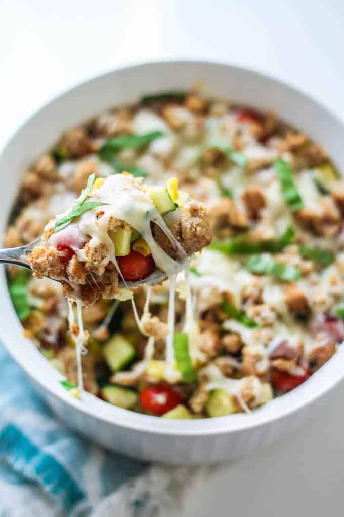 Zucchini, Corn, and Tomato Casserole | Destination Delish - An Italian inspired dish celebrating summer produce topped off with crispy bread cubes and melted mozzarella