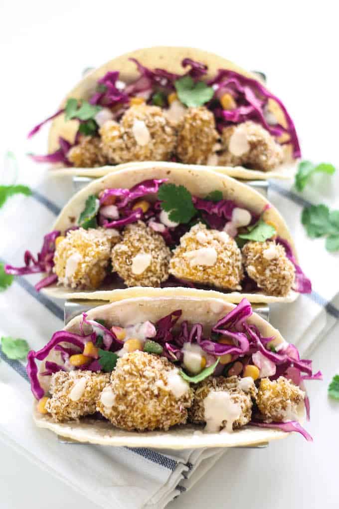 Crispy Cauliflower Tacos | Destination Delish - healthy tacos bursting with flavor and texture thanks to the crispy baked cauliflower, tangy slaw, and spicy chipotle cream