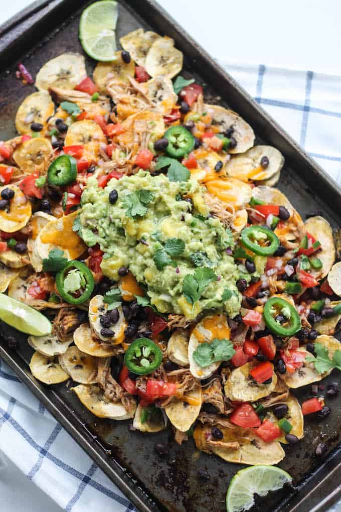 Pulled Pork Plantain Nachos | Destination Delish - healthier nachos using baked plantain wedges topped with tender pulled pork, black beans, and all your fave toppings