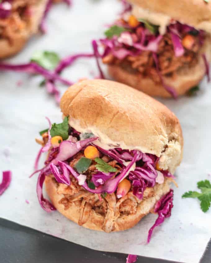 Southwest Pulled Pork Sliders | Destination Delish - mini sandwiches packed with flavor from the boldly seasoned pulled pork, corn and jalapeño slaw, and spicy chipotle mayo.