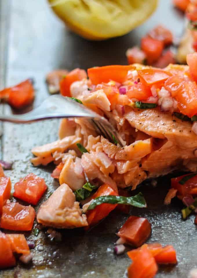 Roasted Salmon with Tomato Basil Relish | Destination Delish – a quick and easy recipe for roasted salmon topped with a vibrant, tangy, and fresh Italian-inspired relish. 