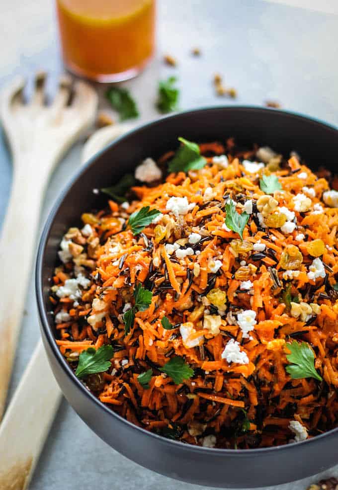 Shredded Carrot and Wild Rice Salad | Destination Delish – a vibrant blend of carrots, wild rice, feta, raisins, and walnuts tossed in a tangy harissa dressing