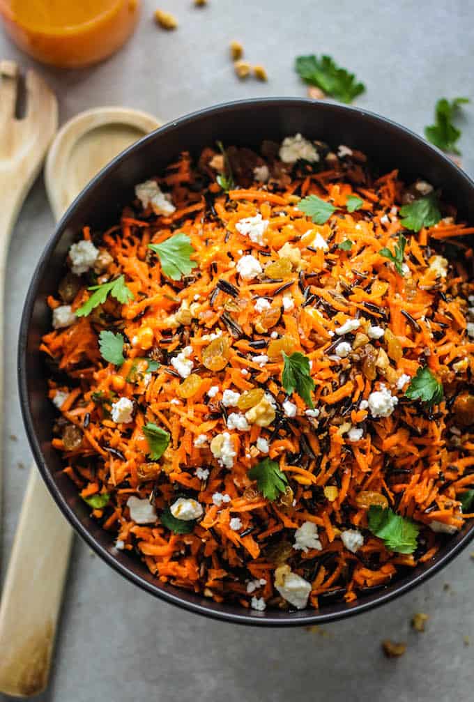 Shredded Carrot and Wild Rice Salad | Destination Delish – a vibrant blend of carrots, wild rice, feta, raisins, and walnuts tossed in a tangy harissa dressing