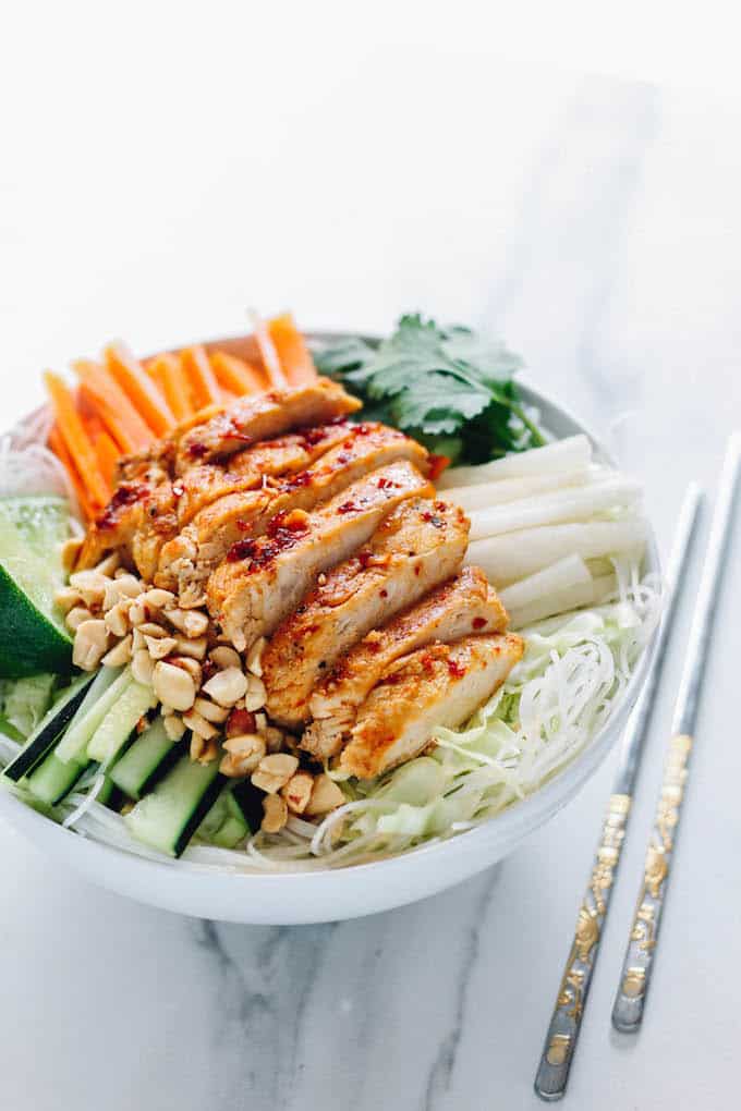 Sweet Chili Glazed Chicken Rice Noodle Bowls | Destination Delish – A healthy rice noodle salad with tangy chicken, zesty veggies, tender rice noodles, and crunchy chopped peanuts