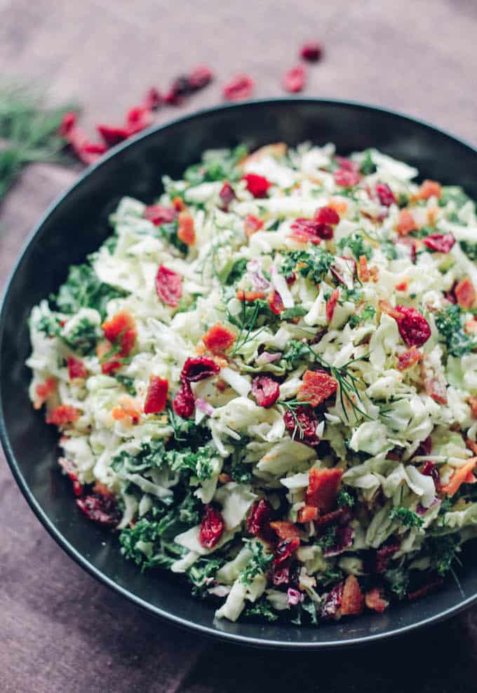 Bacon, Cranberry, Kale Coleslaw | Destination Delish – A delightful coleslaw made lighter with Greek yogurt dressing. It’s full of crunchy texture and little punches of flavor from the bacon and dried cranberries. Easy, gluten-free.