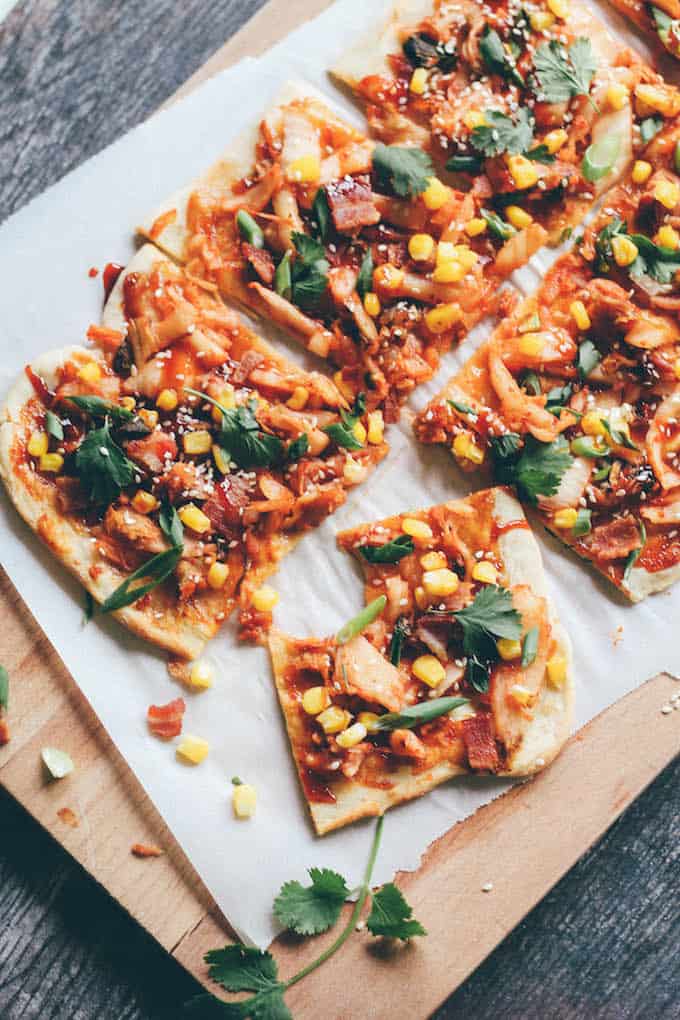 Kimchi, Bacon, and Corn Pizza | Destination Delish - A flatbread pizza bursting with flavor! Topped with kimchi, salty bacon, sweet corn, and Korean BBQ sauce, this is one unforgettable pizza. 