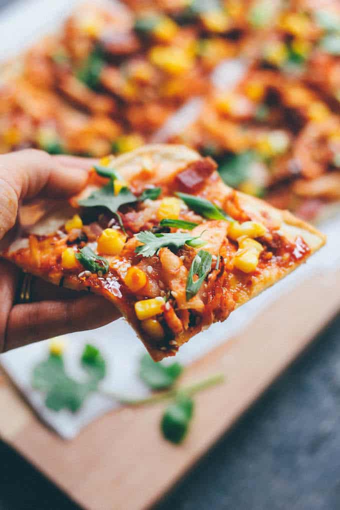Kimchi, Bacon, and Corn Pizza | Destination Delish - A flatbread pizza bursting with flavor! Topped with kimchi, salty bacon, sweet corn, and Korean BBQ sauce, this is one unforgettable pizza. 
