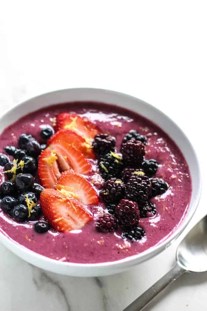 Lemon Berry Smoothie Bowls | Destination Delish – An easy, 4-ingredient smoothie bowl recipe using frozen berries and milk with a splash of fresh lemon juice. These bowls make a wonderfully satisfying and refreshing breakfast, snack, or dessert. 