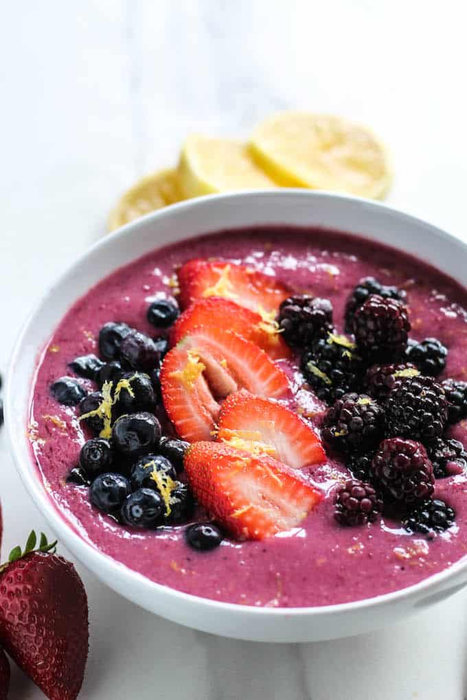 Lemon Berry Smoothie Bowls | Destination Delish – An easy, 4-ingredient smoothie bowl recipe using frozen berries and milk with a splash of fresh lemon juice. These bowls make a wonderfully satisfying and refreshing breakfast, snack, or dessert. 