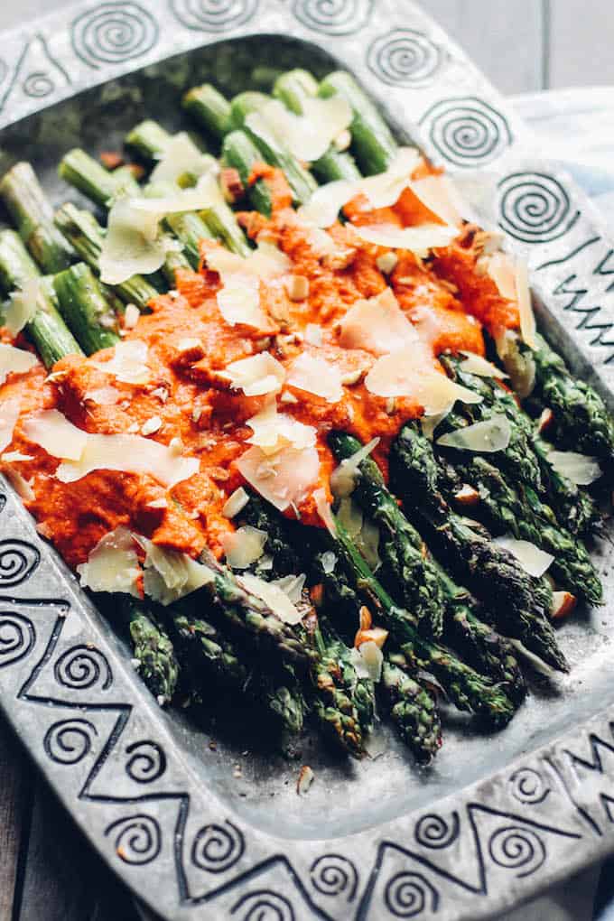 Grilled Asparagus with Romesco | Destination Delish – Tender grilled asparagus with tangy red pepper sauce make up this easy and healthy side dish. Pair it with your favorite grilled protein for the ultimate summer meal!