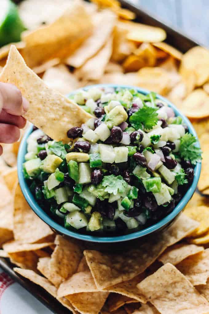 Jicama Black Bean Salsa | Destination Delish – a simple salsa with some serious crunch from the jicama and creaminess from the black beans and avocado. Serve with tortilla chips or top your grilled meat and seafood with it! 
