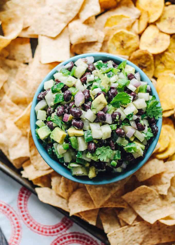 Jicama Black Bean Salsa | Destination Delish – a simple salsa with some serious crunch from the jicama and creaminess from the black beans and avocado. Serve with tortilla chips or top your grilled meat and seafood with it! 
