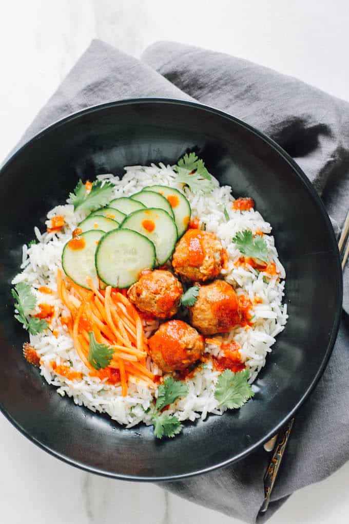 Thai Turkey Meatballs over Ginger Coconut Basmati Rice | Destination Delish – Red curry-spiced meatballs with chili garlic sauce served over authentic basmati rice simmered in coconut milk and infused with fresh ginger