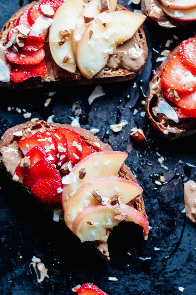  Strawberry, Peach, and Almond Butter Toast | Destination Delish – give your morning toast an upgrade with a smear of nut butter, fresh strawberries and peaches, and a sprinkle of coconut flakes for a healthy and filling breakfast!