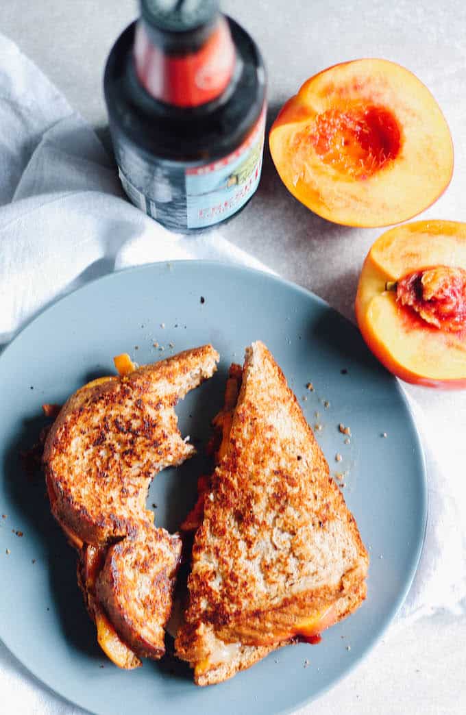 Peach, Bacon, and Fontina Grilled Cheese | Destination Delish – a sweet and savory sandwich filled with juicy summer peaches, salty bacon, and gooey cheese. Enjoy this grilled cheese as a quick and easy weeknight dinner!