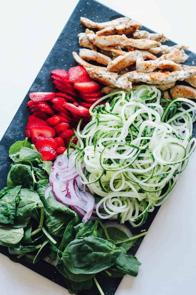 Strawberry Poppyseed and Cucumber Noodle Spring Rolls | Destination Delish – sweet strawberries, tender chicken, cucumber noodles, and spinach all rolled up into a fresh spring roll with dressing to dip on the side. It’s a light and refreshing appetizer to enjoy on those hot summer days!