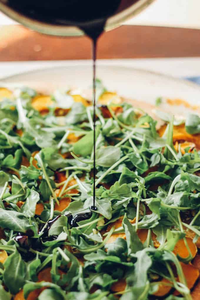 Acorn Squash Arugula Pizza - Toppings include roasted acorn squash, feta cheese, arugula, and a drizzle of balsamic. A healthy option for pizza night!