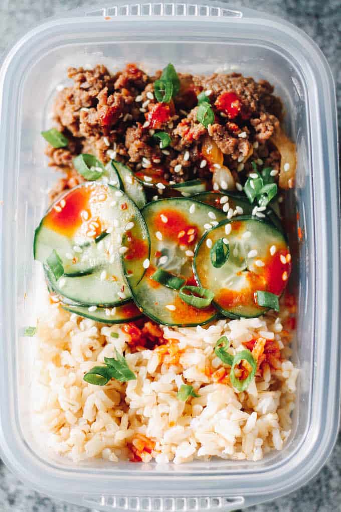 Korean Beef Meal Prep Bowls | Destination Delish - Your new favorite lunch: Korean ground beef paired with crisp and tangy cucumbers served on a bed of rice. Less than 20 minutes in the kitchen yields a week of lunches!