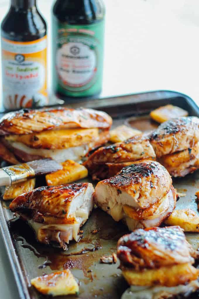 Grilled Hawaiian Stuffed Chicken | Destination Delish - grilled chicken breasts brushed with a pineapple teriyaki glaze and stuffed with ham, pineapple, and provolone cheese. Summer grilling perfection!