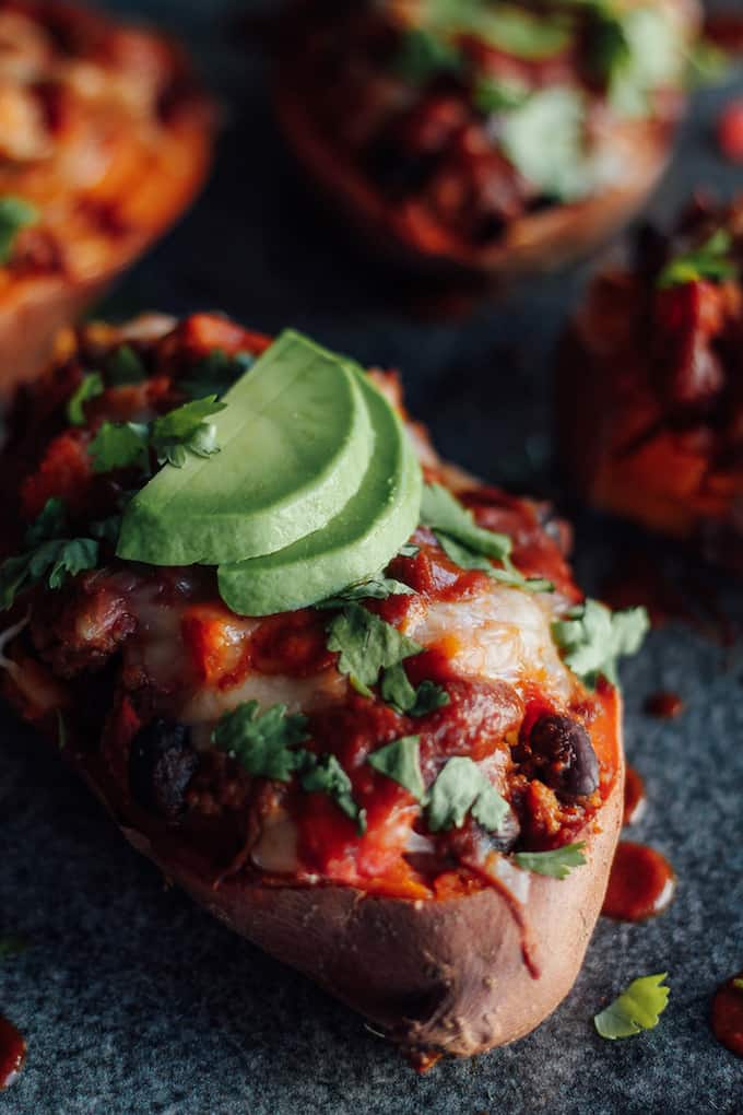Turkey Enchilada Stuffed Sweet Potatoes | Destination Delish - Saucy southwest flavored ground turkey and sautéed veggies packed inside a sweet potato and topped with gooey melted cheese. An easy and healthy weeknight meal the whole family will love! 