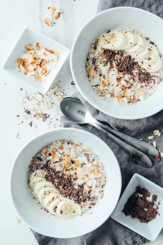 Toasted Coconut, Banana, and Chocolate Muesli | Destination Delish - A cozy oats breakfast that can be served warm or cold! Top with extra chocolate shavings and banana slices for a wholesome and healthy morning treat!