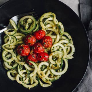 Zucchini Noodles with Kale Almond Pesto | Destination Delish - Spiralized zucchini pasta tossed with a healthy pesto of kale, almonds, garlic, olive oil, and lemon juice.