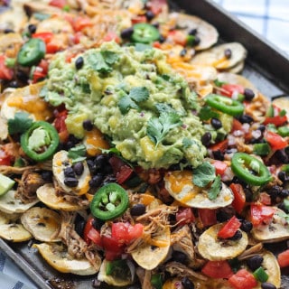 Pulled Pork Plantain Nachos | Destination Delish - healthier nachos using baked plantain wedges topped with tender pulled pork, black beans, and all your fave toppings!