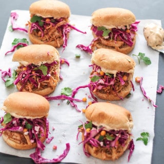 Southwest Pulled Pork Sliders | Destination Delish - mini sandwiches packed with flavor from the boldly seasoned pulled pork, corn and jalapeño slaw, and spicy chipotle mayo.