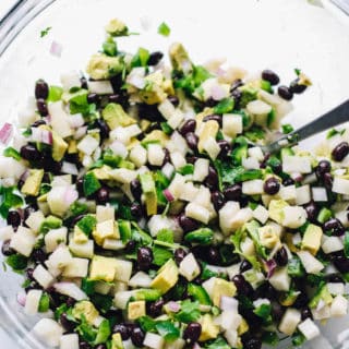 Jicama Black Bean Salsa | Destination Delish – a simple salsa with some serious crunch from the jicama and creaminess from the black beans and avocado. Serve with tortilla chips or top your grilled meat and seafood with it!