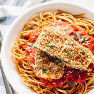Baked Zucchini Parmesan | Destination Delish - Breaded zucchini baked until crispy on the outside and tender on the inside. Then, topped with marinara. It’s healthy, vegetarian take on the Italian classic.