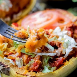 A bite coming out of one cheeseburger spaghetti squash boat