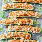 Buffalo chicken zucchini boats topped with blue cheese and chopped celery