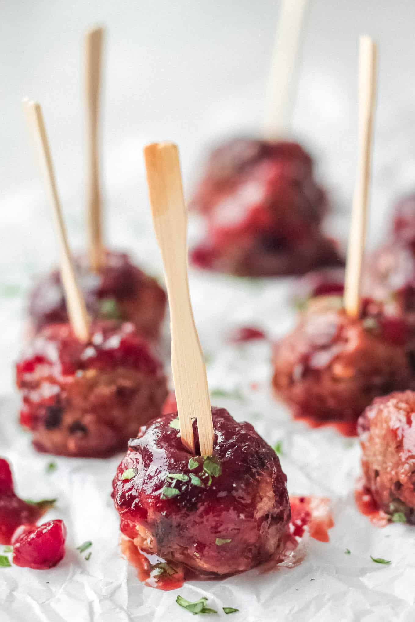 Meatballs with toothpicks on parchment paper