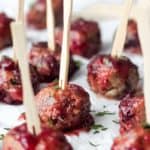 Meatballs with toothpicks on parchment paper