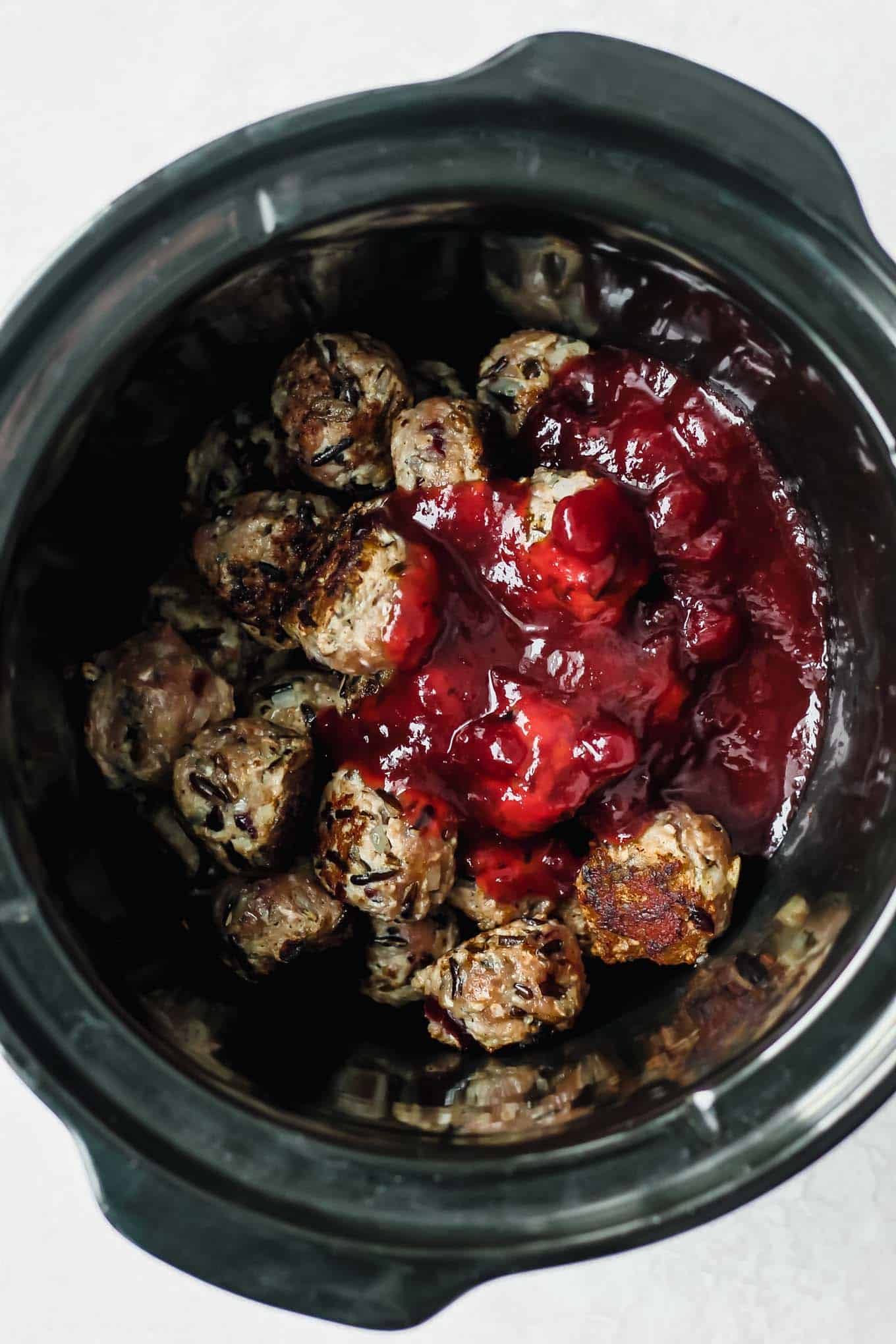 Meatballs in the slow cooker with sauce poured over