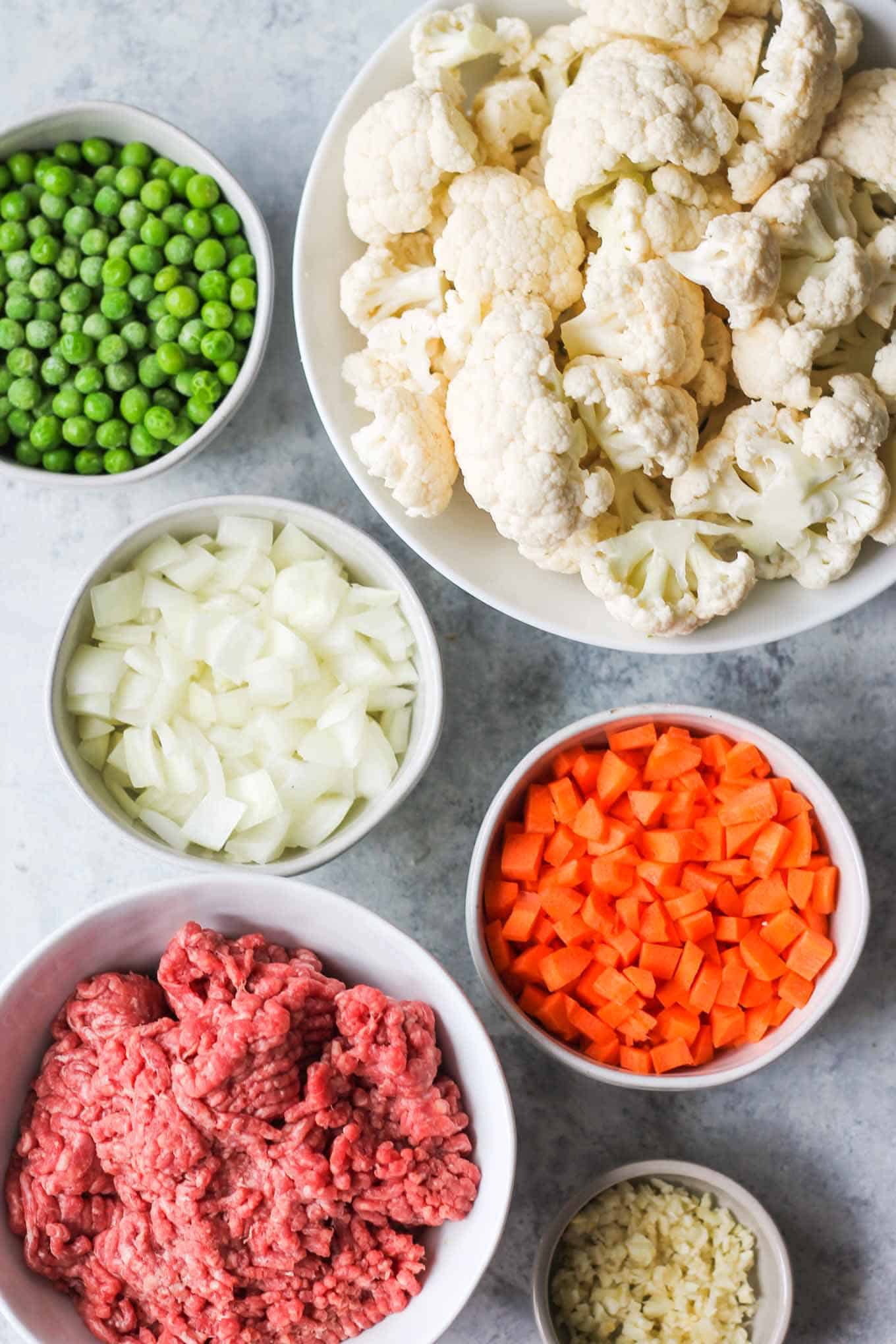 The shepherd's pie ingredients separated into bowls before cooking.
