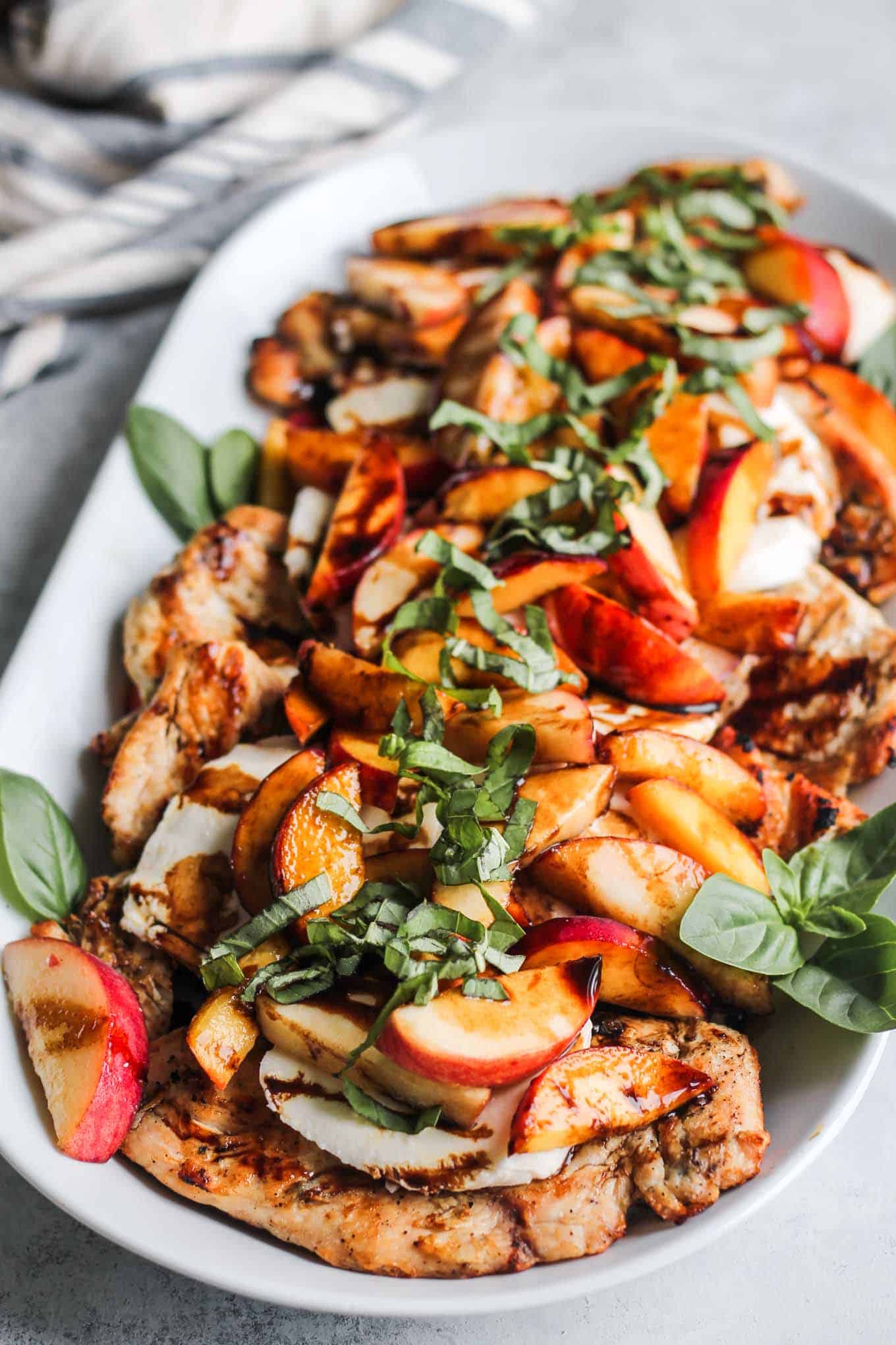 The Peach Caprese Grilled Chicken plated on a platter and ready to serve.